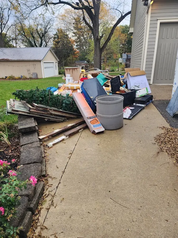 Dumpster being loaded with debris for Commercial Dumpster Rental in Crockery